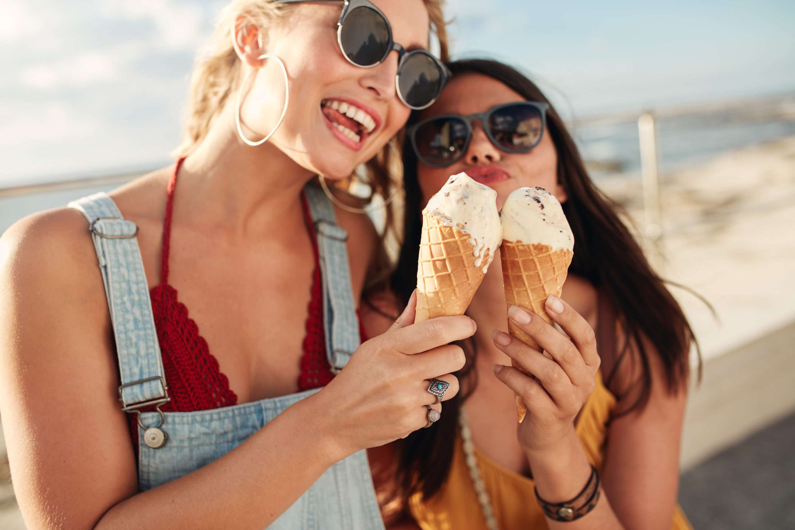 Two young women eating an ice cream together